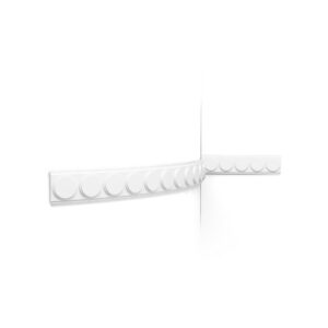 White decorative plaster molding with circular reliefs against a white wall surface